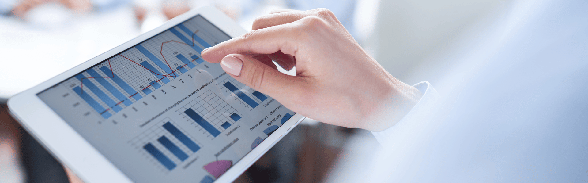 Female looking at financial charts on digital device