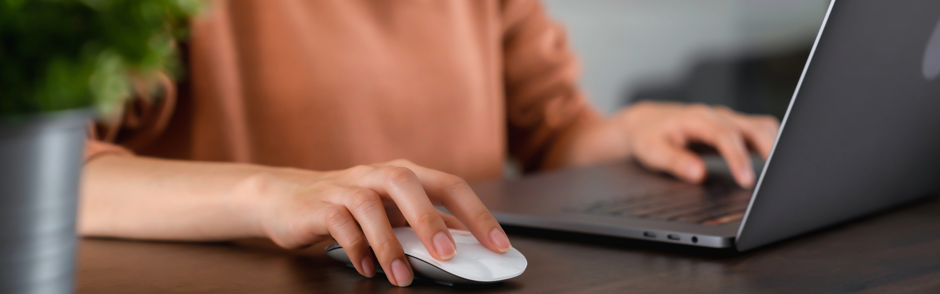A category manager working at their desk on a laptop.