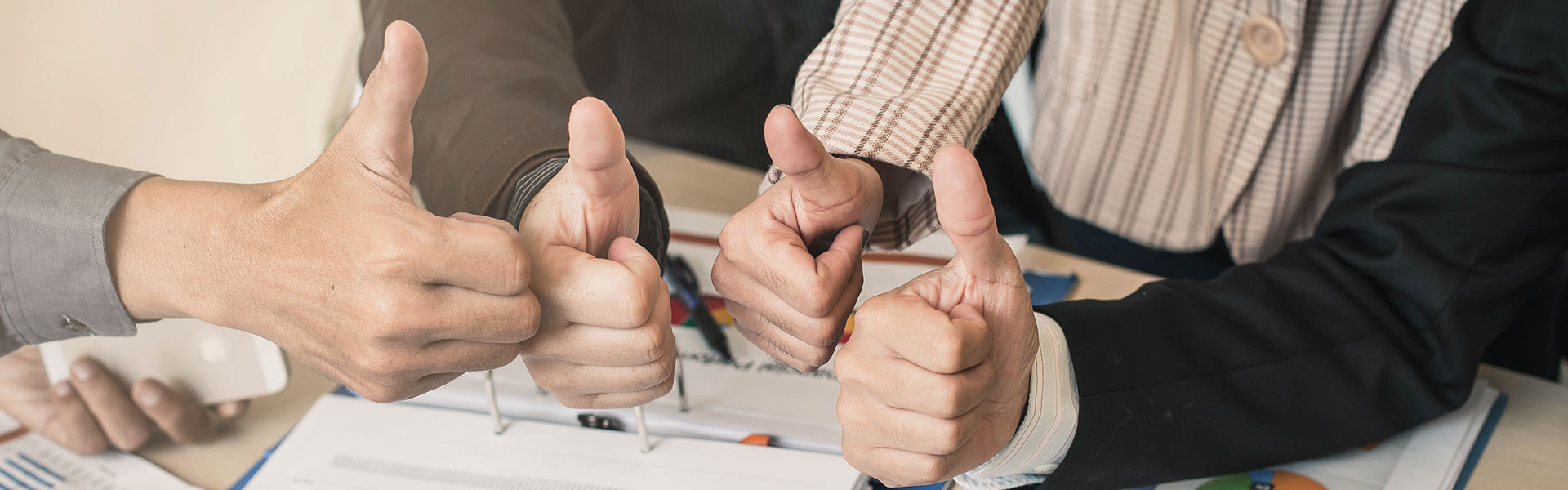 Opening up opportunities at NHS Shared Business Services. Multiple people in an office with their thumbs up