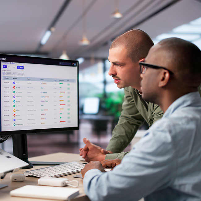 Procurement-Manager-And-Colleague-Discuss-Software-Platform
