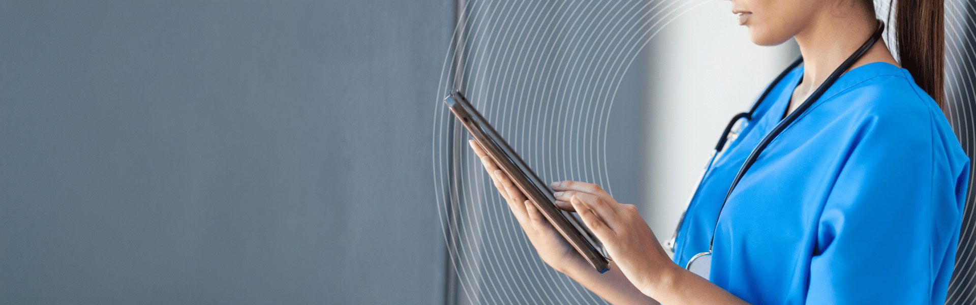 Young female nurse looking at an electronic device