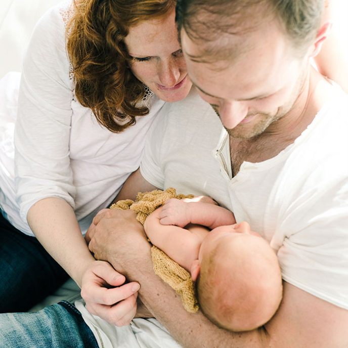 Understanding your Maternity Pay, a couple holding a baby