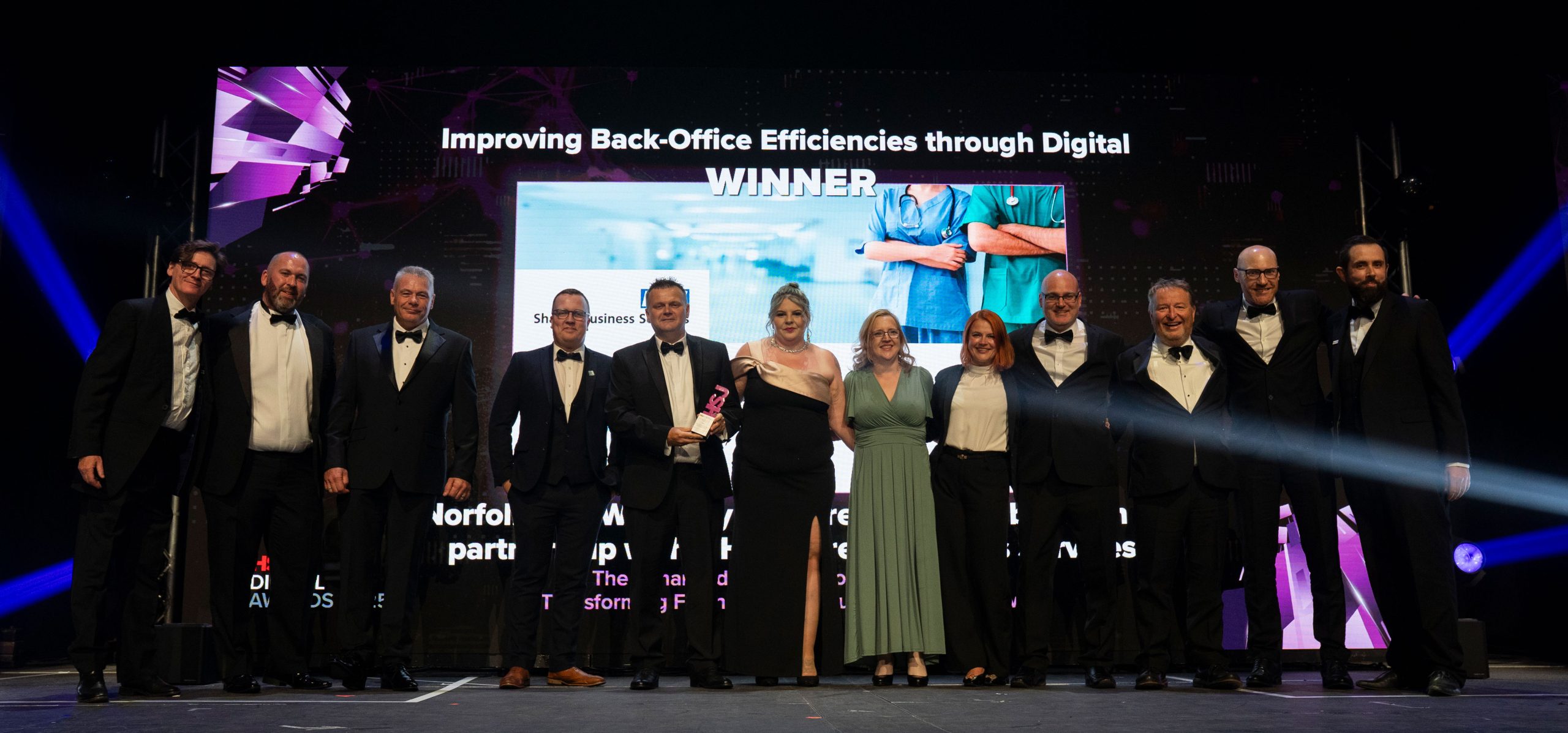 NHS SBS celebrate on stage after winning the HSJ Digital Award 2025