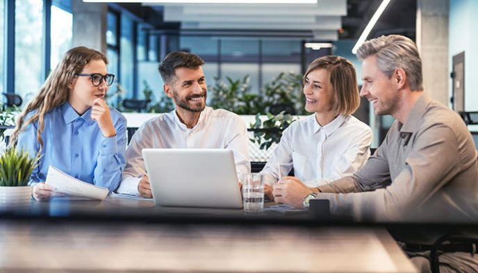 business team on meeting in modern bright office interior identifying the best solutions and building strong business cases, working on laptop and tablet computer.