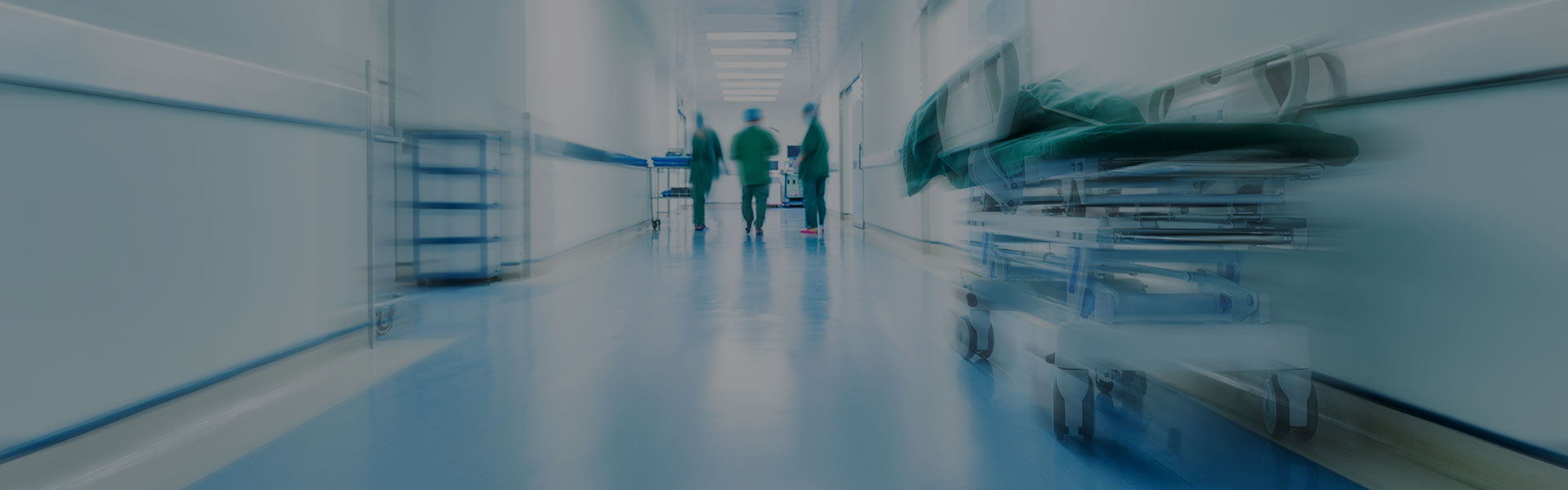 Doctors or nurses walking in hospital hallway, blurred motion