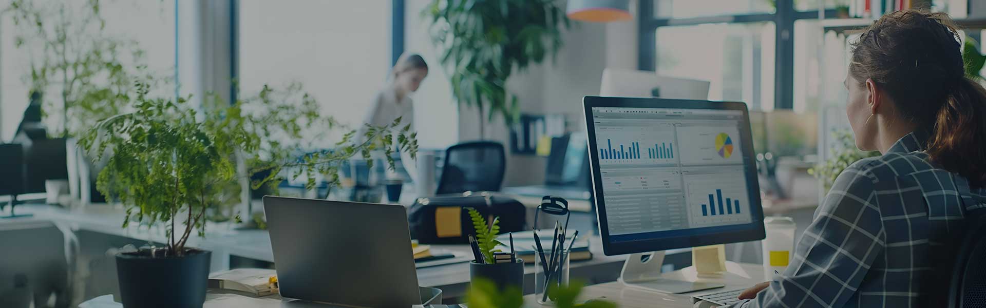 Woman sat at the desk looking at the Data Driven Decisions: Navigating Modern Business - Analyzing Success: Metrics That Matter