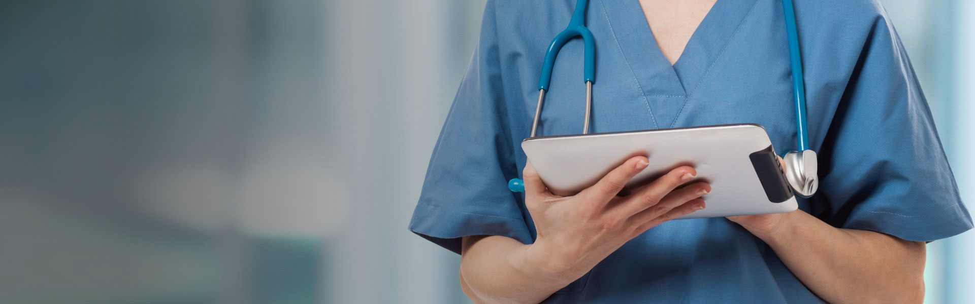 a nurse holding a computer tablet