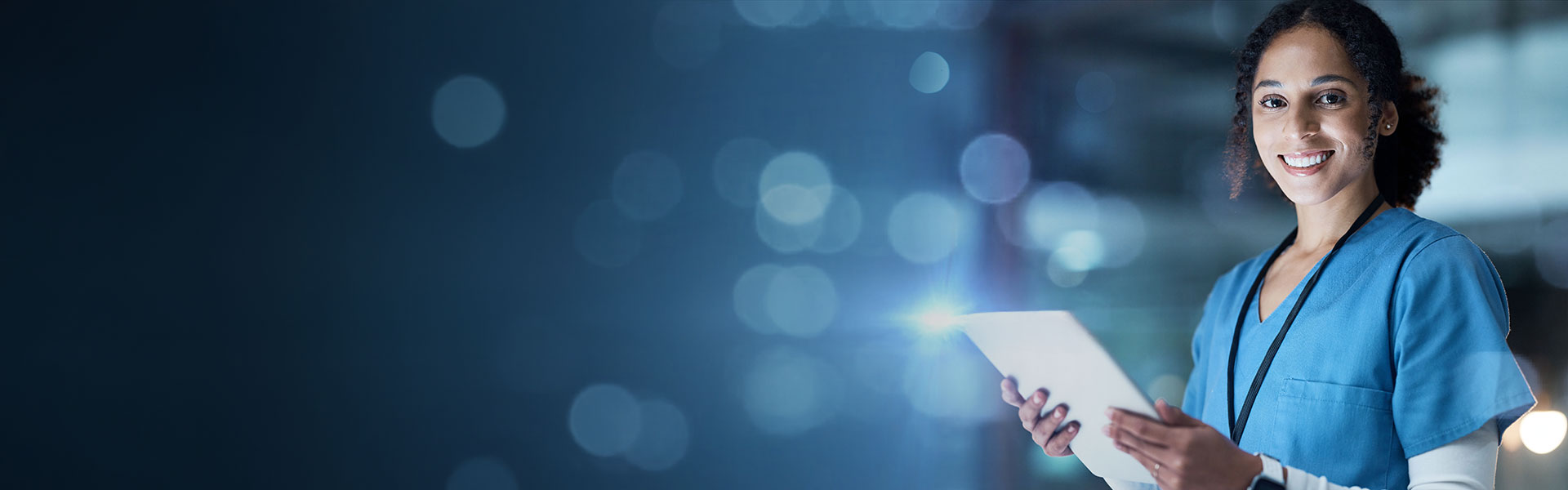 Smile, happy woman doctor using a computer tablet