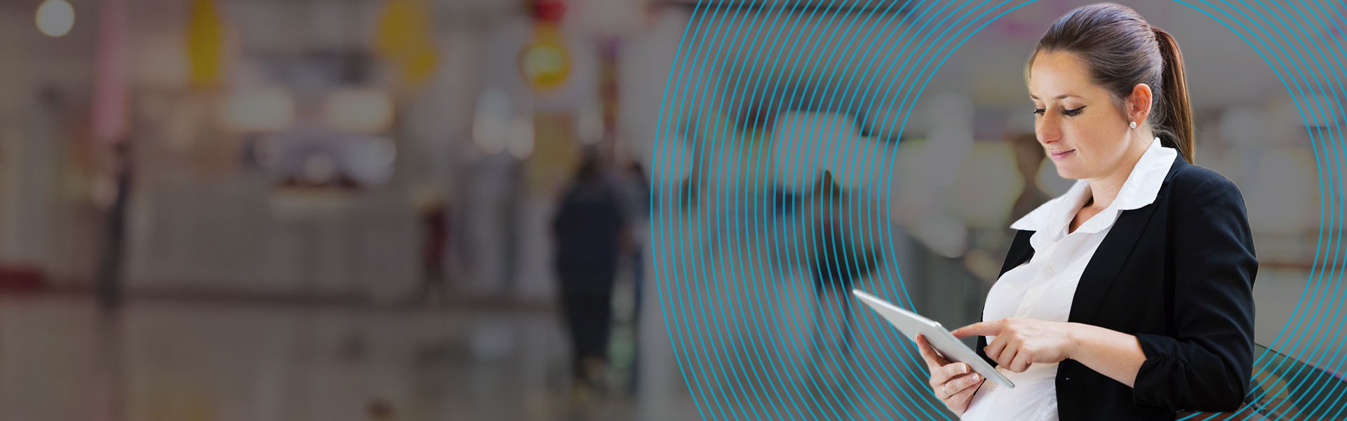 Pregnant NHS worker using a tablet to check her maternity pay with the NHS maternity pay calculator.