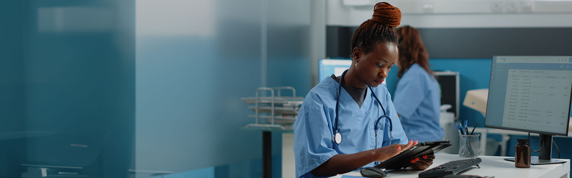 nurse holding digital tablet for checkup visit in doctors office. Black woman working as medical assistant, using device with touch screen for healthcare and medicine