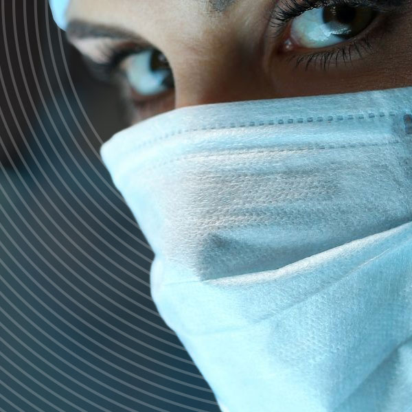 a close up of an NHS surgeons face in theatre