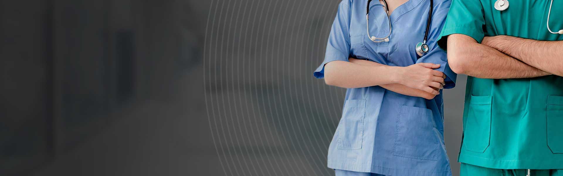 Two hospital staffs - surgeon, doctor or nurse standing with arms crossed in the hospital. Medical healthcare and doctor service.